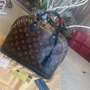 Louis Vuitton Alma with gold and silver studs.